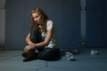 Girl sad sitting on floor due to abandonment divorce in New York